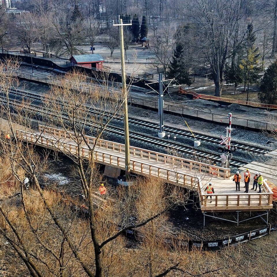Aerial view of the Waterloo Park Promenade Boardwalk.  Timber framed ramp on helical piles.  Designed to provide access up to a train track crossing.