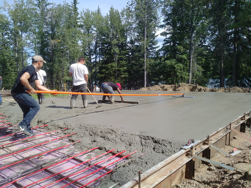 Floating slab under construction.  Men are troweling the concrete.