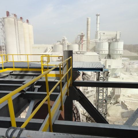 Structural steel being installed at a cement plant.  View from a tower 250 ft up.