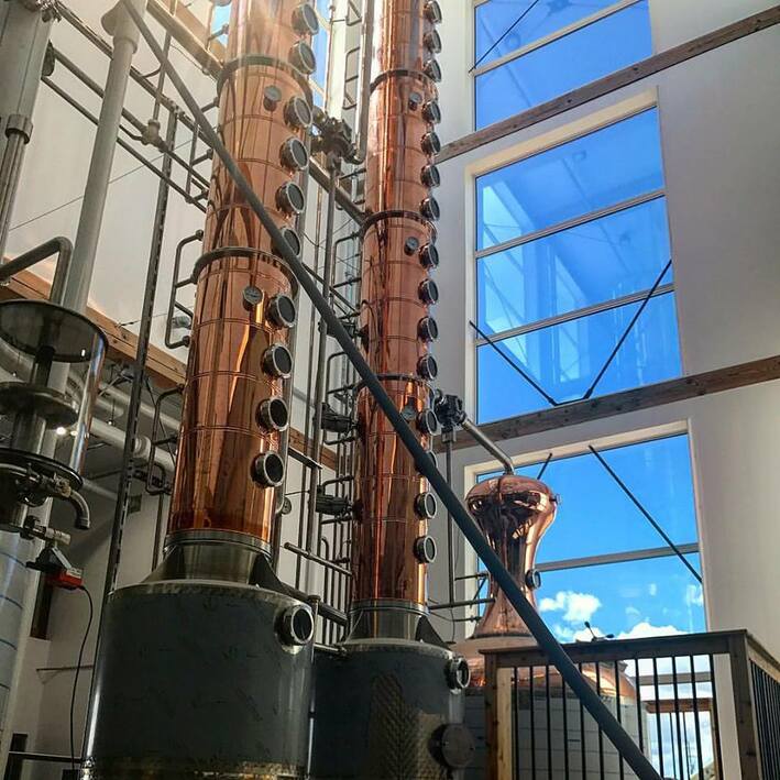 Vodka distillery building with stills in a timber framed tower.  