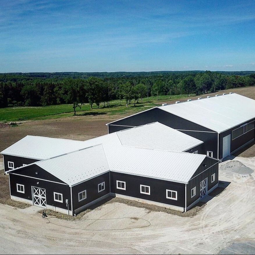 Horse Barn with 80x160 riding arena and stable out front.  Drone picture.