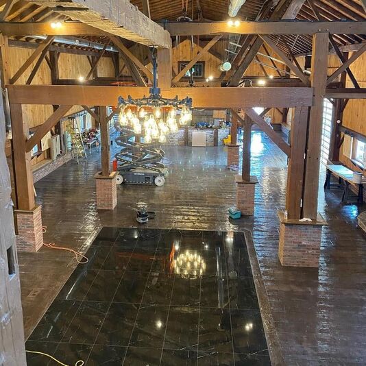 Barn restoration for a wedding barn .  Interior timber framing and dance floor.  