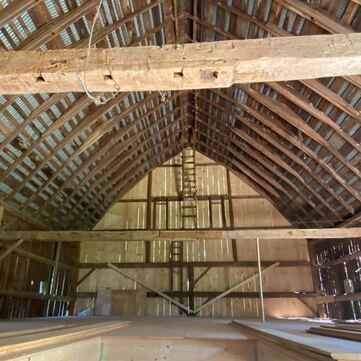 Interior of a restored timber barn.  Barn wedding venue.