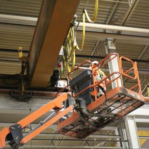 Gantry crane inspection.  Inspector is in a manlift reviewing the crane.  