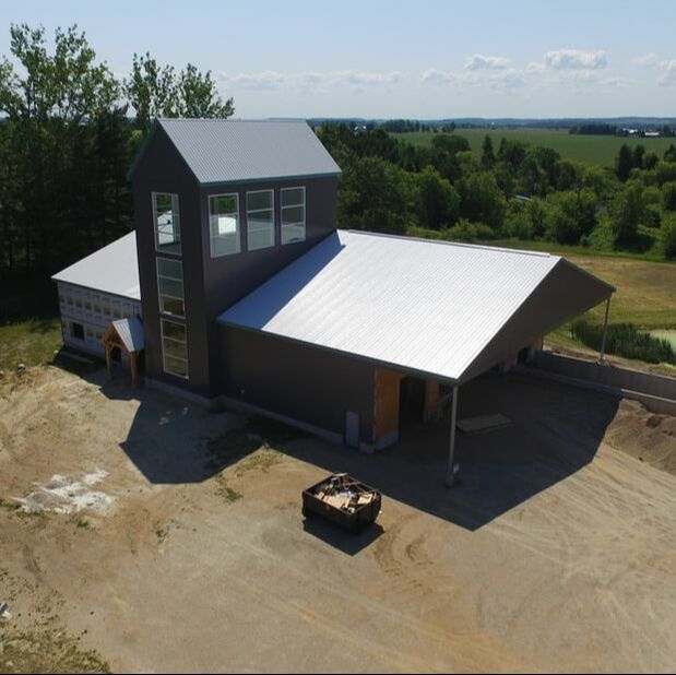Vodka distillery building with stills in a timber framed tower.    Aerial view from a drone.  