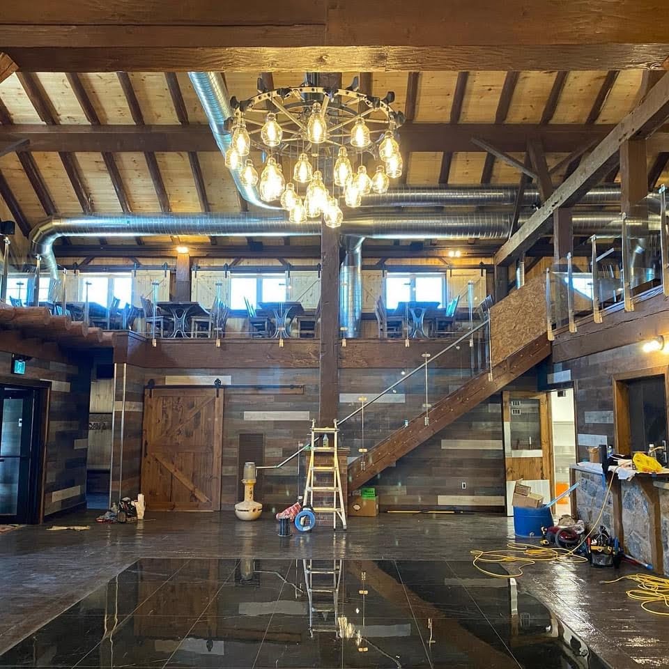 Barn restoration for a wedding barn.  Interior timber framing and dance floor.
