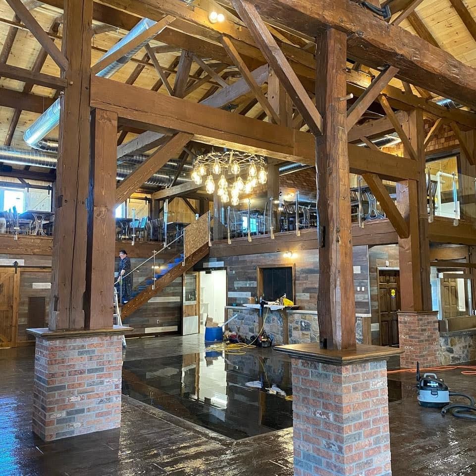 Barn restoration for a wedding barn .  Interior timber framing and dance floor.