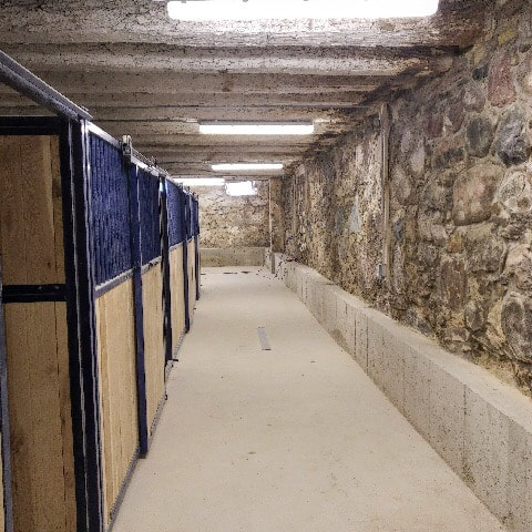 Horse stables in an old bank barn that had underpinning work done to lower the floors.  The floor was lowered to provide more head room in the barn.  A concrete wall was poured under the rubble foundation.